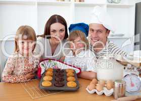 Cheerful family presenting their muffins