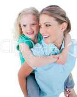 Caucasian mother giving her daughter piggyback ride