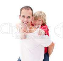 Blond little boy enjoying piggyback ride with his father