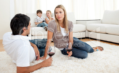 Romantic couple talking with glasses of wine