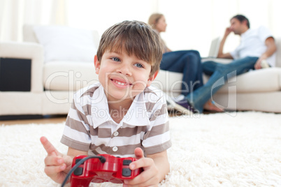 Smiling little boy playing video games