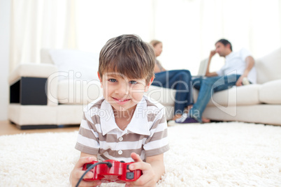 Adorable little boy playing video games
