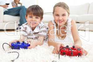 Cute brother and sister playing video games