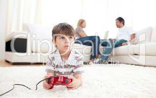 Cute little boy playing video games