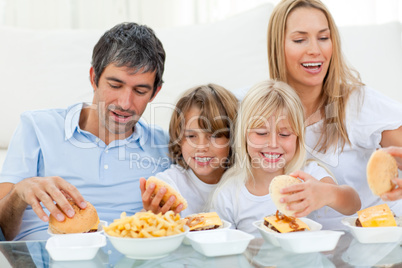 Loving family eating hamburgers