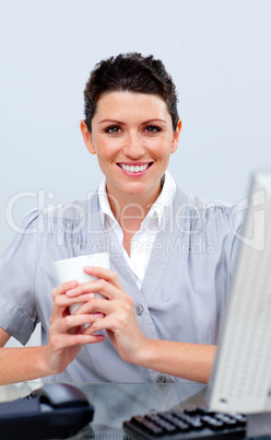 Positive business woman drinking coffee