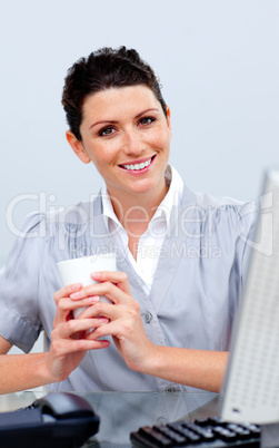 Smiling business woman drinking coffee