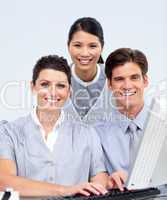 Portrait of three colleagues working at a computer