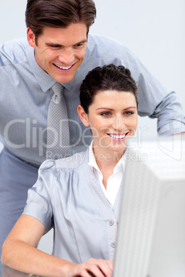 Confident business woman and her colleage working at a computer