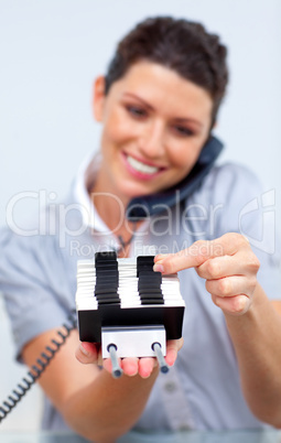 Smiling business woman on phone searching for the index