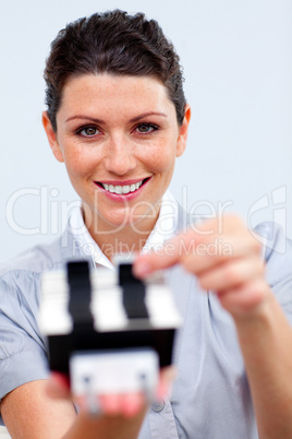 Positive businesswoman consulting a business card holder