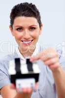 Positive businesswoman consulting a business card holder