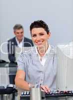 Confident business woman working at a computer