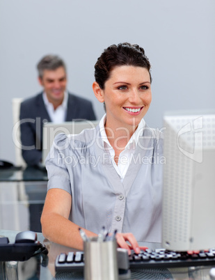 Smiling business woman working at a computer