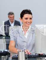 Smiling business woman working at a computer