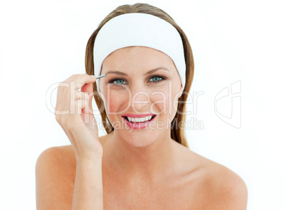 Attractive woman using tweezers