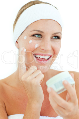 Jolly woman putting cosmetic cream