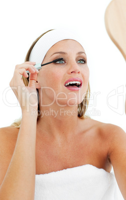 Blond woman putting mascara