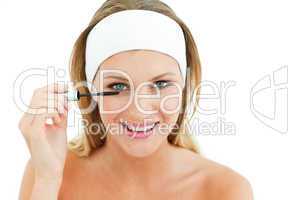 Attractive woman putting mascara