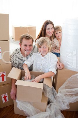 Happy family packing boxes