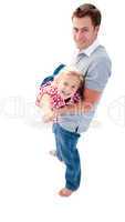 Adorable blond child enjoying piggyback ride with her father