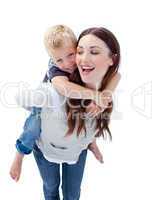Joyful mother giving her son piggyback ride