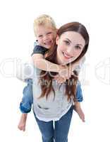 Close-up of brunette mother giving her son piggyback ride