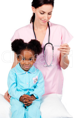 Female nurse taking little girl's temperature