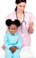 Female nurse taking little girl's temperature