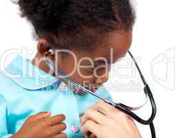 Little girl playing with a stethoscope at a medical check-up