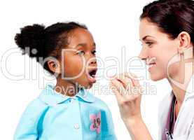 Smiling doctor taking little girl's temperature