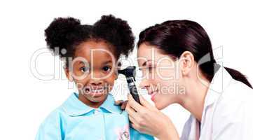 Smiling doctor checking her patient's ears