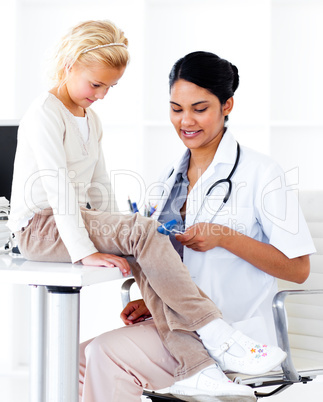 Attentive female doctor checking her patient's reflex