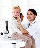 Smiling female doctor checking her patient's ears