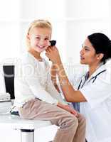 Concentrated female doctor checking her patient's ears