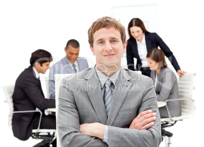 Caucasian businessman sitting in front of his team