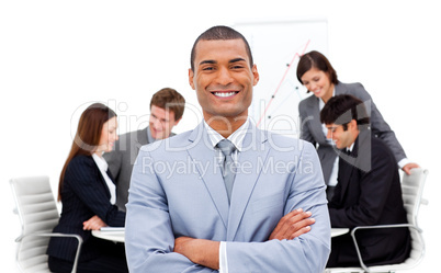 Ethnic businessman sitting in front of his team