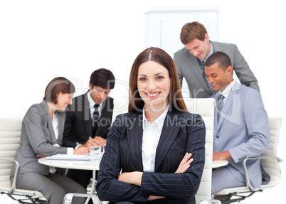 Confident manager with folded arms in front on his team