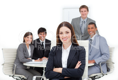 Charismatic female executive sitting in front of her team