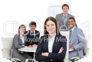 Charismatic female executive sitting in front of her team