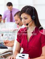Concentrated Businesswoman using headset