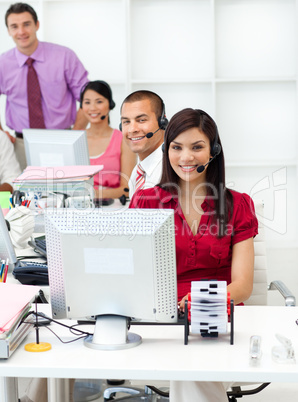 Smiling business people with headset on working