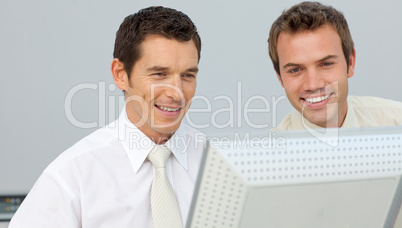 Two businessmen working together at a computer