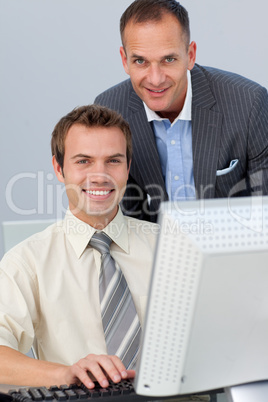 Assertive business partners working together at a computer