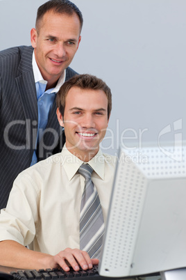 Confident business partners working together at a computer