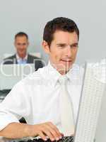 Smiling businessman working at his computer