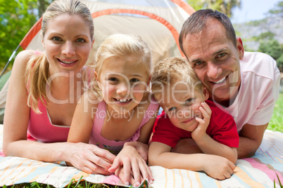 Portrait of a happy family lying on the grass