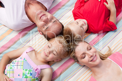 Loving family sleeping lying on the grass