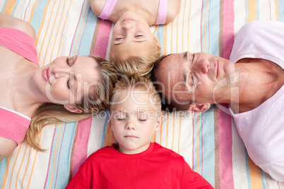 Tired family sleeping lying on the grass