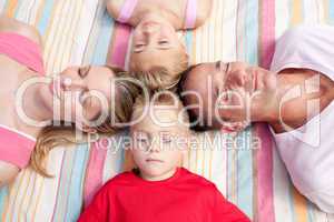 Tired family sleeping lying on the grass